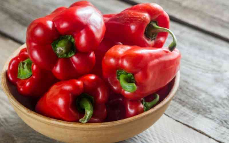 close up shot of red bell peppers in a bowl